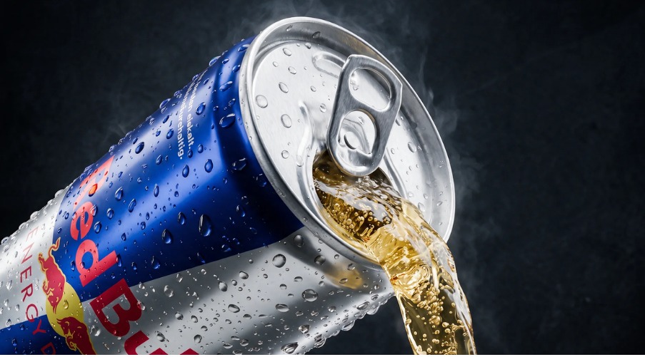 The finished can, chilled with condensation, pouring golden liquid