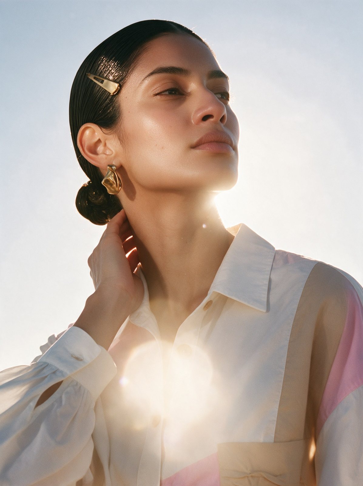 Close portrait of a model in a colour-block shirt with backlight