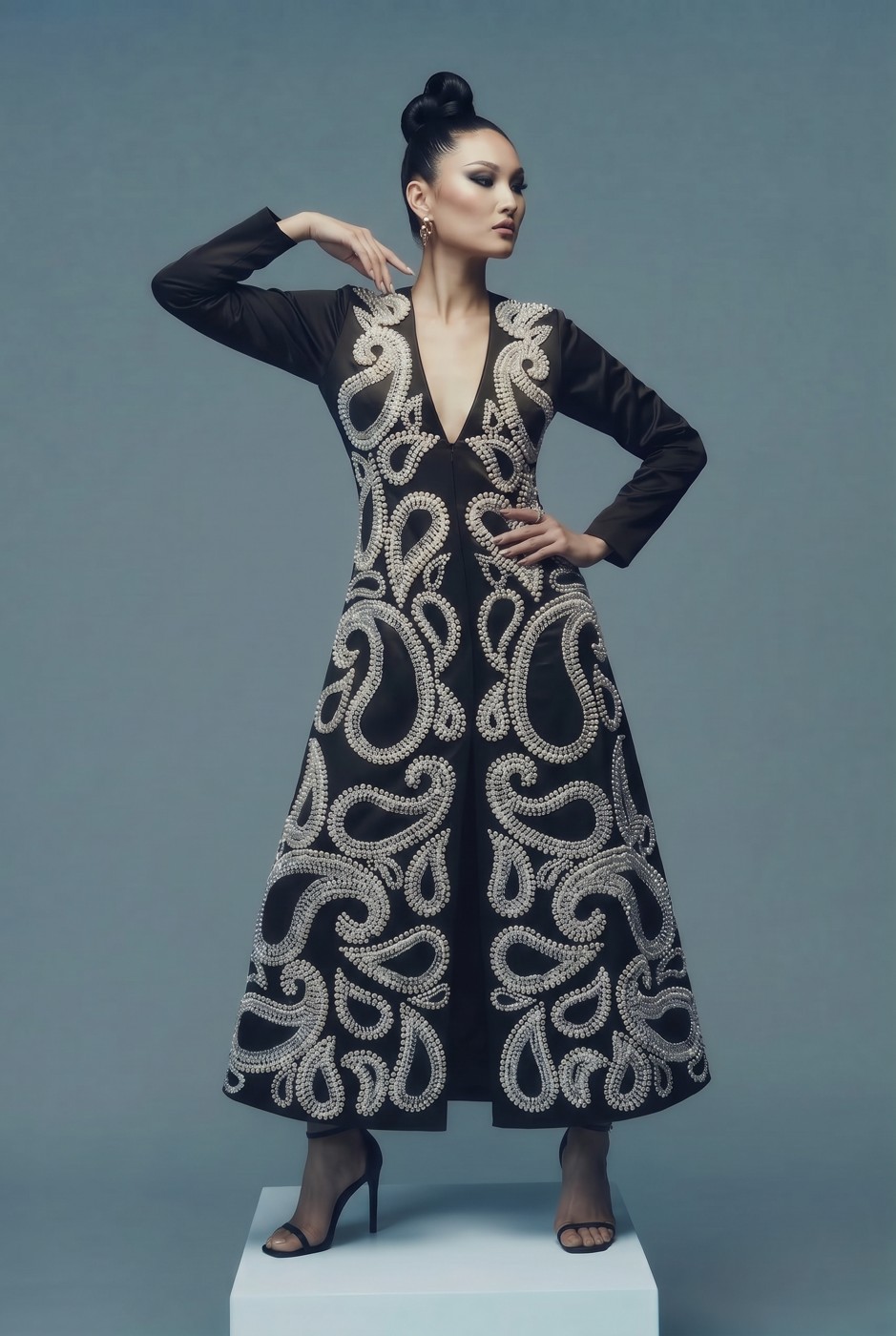 Model in a black gown with pearl paisley embroidery